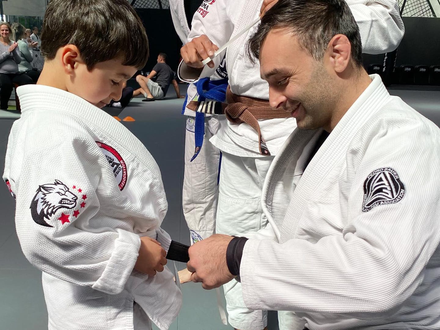 BJJ coach awarding stripe to child